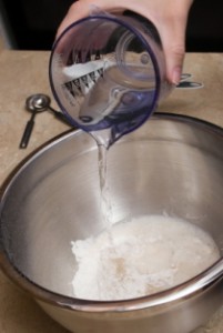 baking beginnings, pouring measured water into baking dish