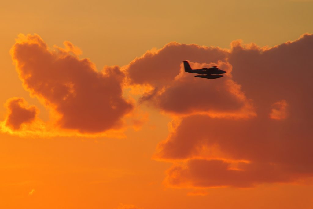 Plane flying at sunset.