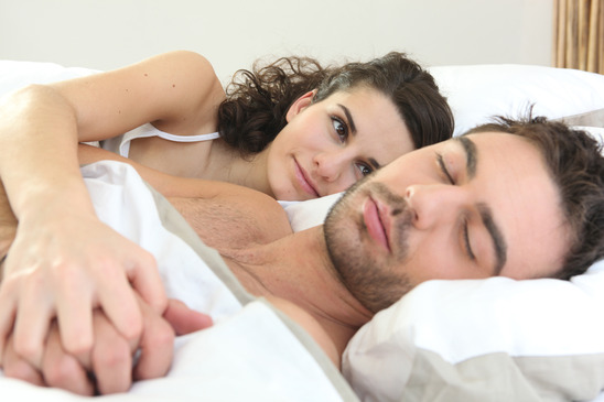 Woman watching her husband sleeping